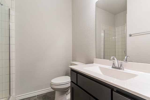 bathroom featuring tile patterned floors, vanity, a shower with door, and toilet