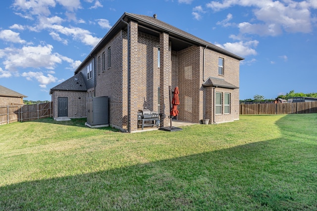 back of property with a patio and a lawn