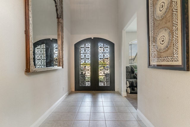 foyer with french doors and light tile patterned flooring