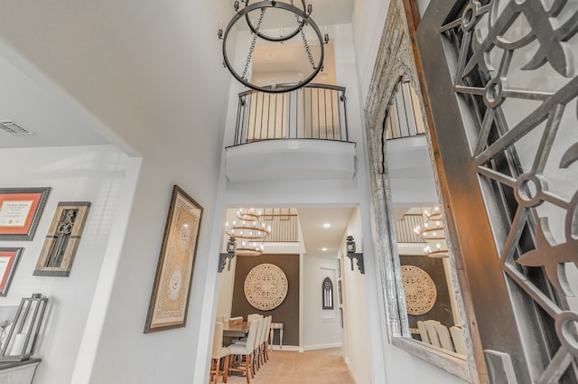 foyer with a towering ceiling and a chandelier