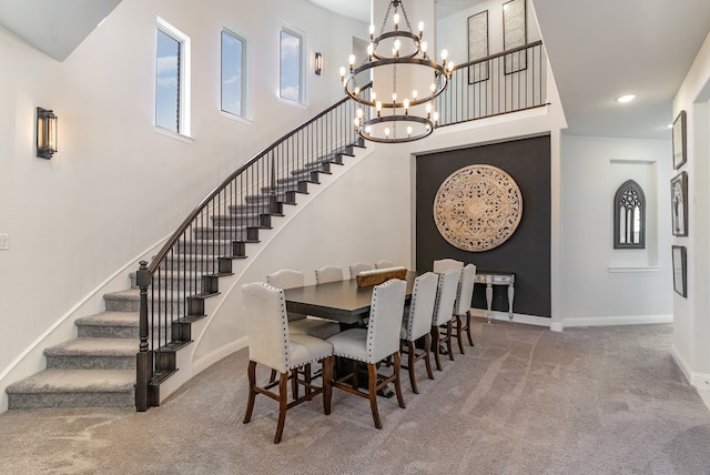 carpeted dining room featuring a notable chandelier