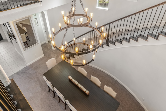 staircase featuring an inviting chandelier, carpet flooring, and a high ceiling