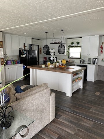 kitchen with dark hardwood / wood-style floors, butcher block countertops, and white cabinets