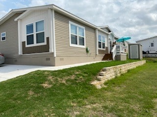 view of property exterior featuring a yard and a shed