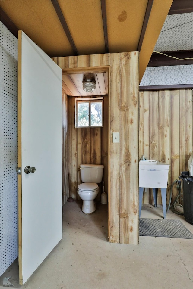 bathroom featuring concrete flooring and toilet