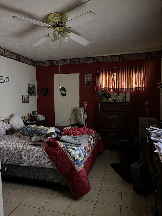 bedroom with ceiling fan and light tile patterned flooring