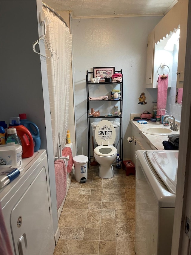 full bathroom featuring vanity, toilet, shower / bathtub combination with curtain, and washer / clothes dryer