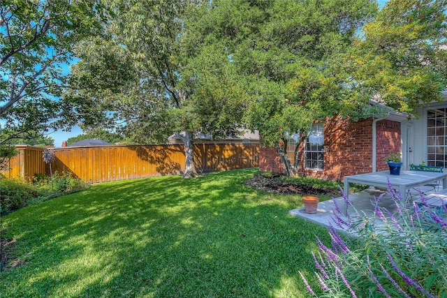 view of yard featuring fence and a patio