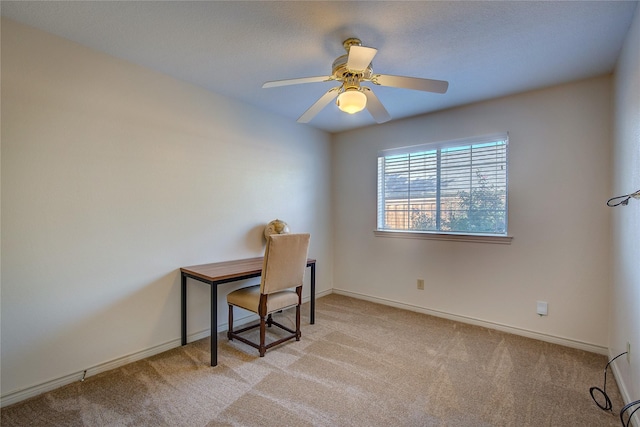 office featuring light carpet, ceiling fan, and baseboards