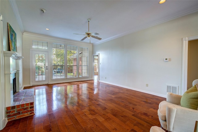 living room with visible vents, crown molding, baseboards, and wood finished floors