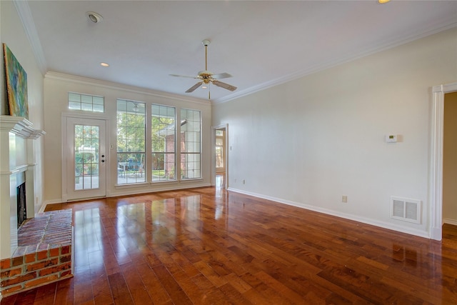 unfurnished living room featuring a brick fireplace, visible vents, hardwood / wood-style floors, and ornamental molding