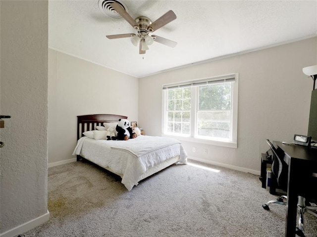 carpeted bedroom featuring crown molding and ceiling fan