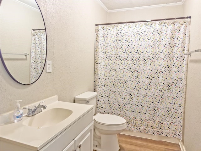 bathroom with toilet, hardwood / wood-style floors, ornamental molding, a shower with shower curtain, and vanity