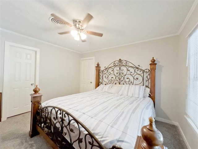 carpeted bedroom with ornamental molding and ceiling fan