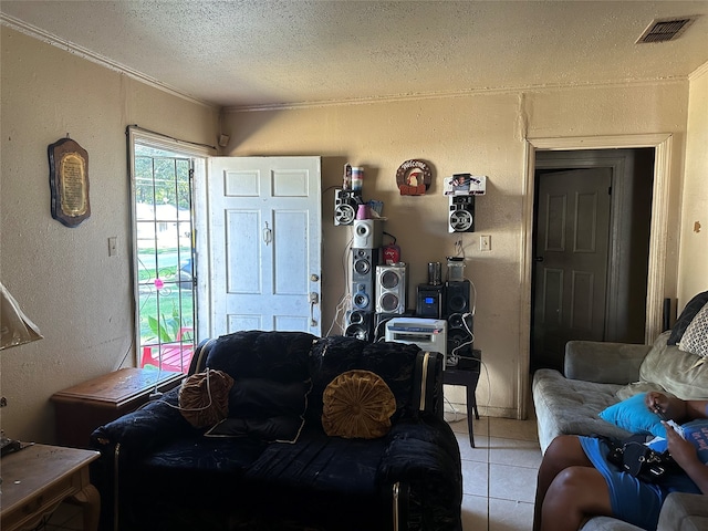 living room with a textured ceiling, crown molding, and light tile patterned floors