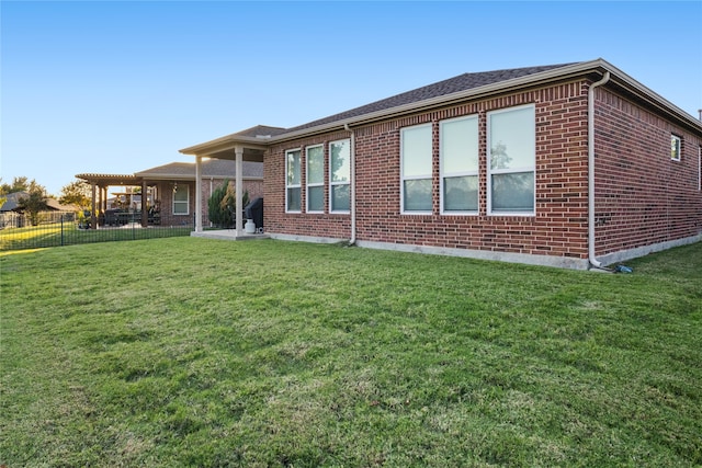 rear view of house featuring a lawn