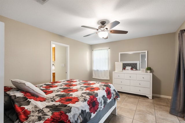 bedroom with ensuite bathroom, ceiling fan, and light tile patterned floors