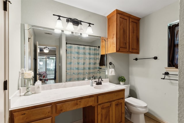 bathroom with ceiling fan, vanity, and toilet