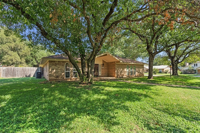 view of front of house featuring a front yard and central AC unit