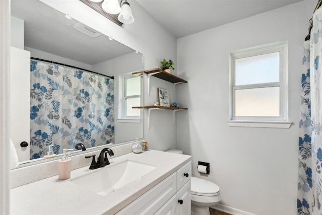 bathroom featuring vanity and toilet