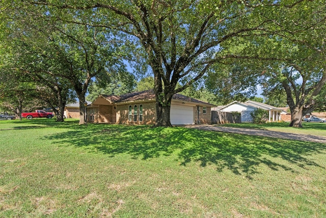 single story home with a garage and a front yard