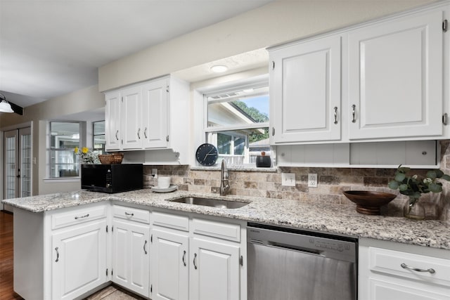 kitchen featuring white cabinets, hardwood / wood-style flooring, sink, kitchen peninsula, and dishwasher