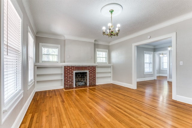 unfurnished living room featuring a textured ceiling, hardwood / wood-style floors, and plenty of natural light