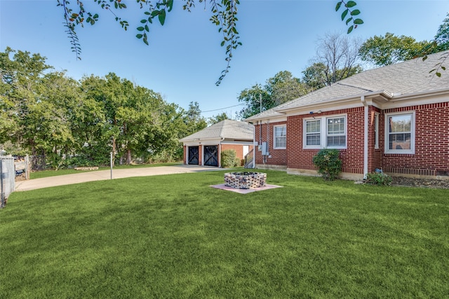 view of yard featuring a garage and an outbuilding