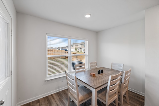 dining area with dark hardwood / wood-style floors