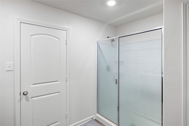 bathroom with a shower with shower door