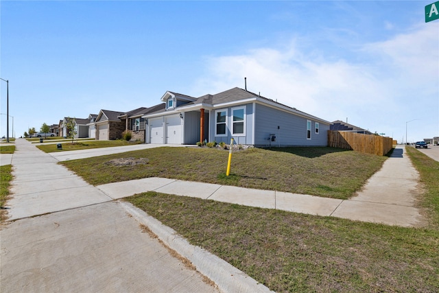 ranch-style home with a garage and a front yard