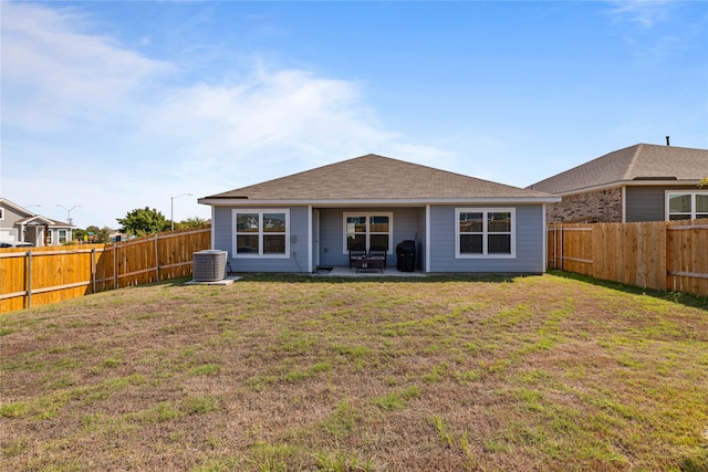 back of property featuring central AC, a patio area, and a lawn