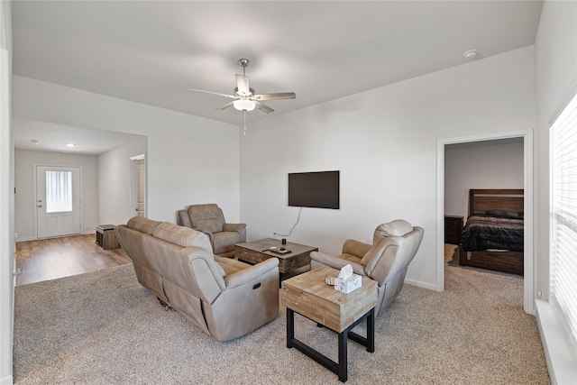 living room with ceiling fan and light wood-type flooring