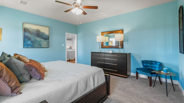 carpeted bedroom featuring ceiling fan and ensuite bath