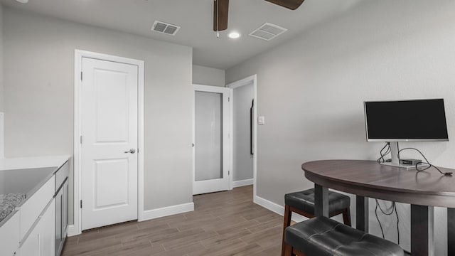 office area with light wood-type flooring and ceiling fan