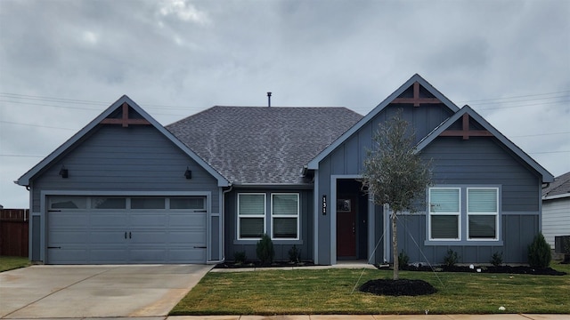 view of front of property with a garage and a front lawn