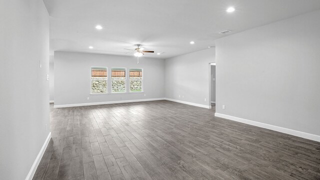 unfurnished room with ceiling fan and dark hardwood / wood-style flooring