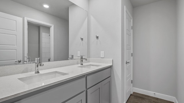 bathroom with hardwood / wood-style flooring and vanity