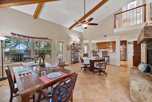 dining space featuring ceiling fan, high vaulted ceiling, and beam ceiling