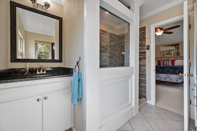 bathroom featuring tile patterned flooring, ornamental molding, walk in shower, vanity, and ceiling fan