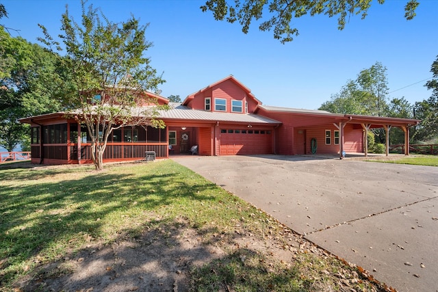 view of front of property with a garage, a front lawn, and a carport