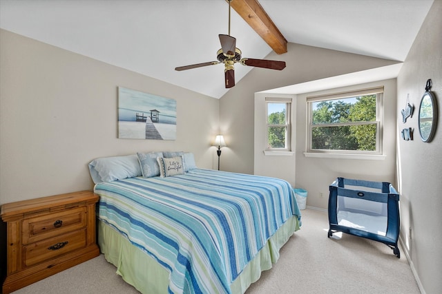 bedroom with ceiling fan, lofted ceiling with beams, and light colored carpet