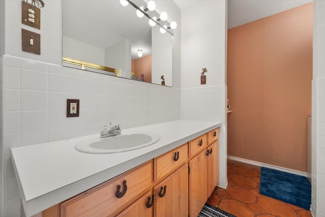 bathroom with vanity, tile patterned floors, and backsplash