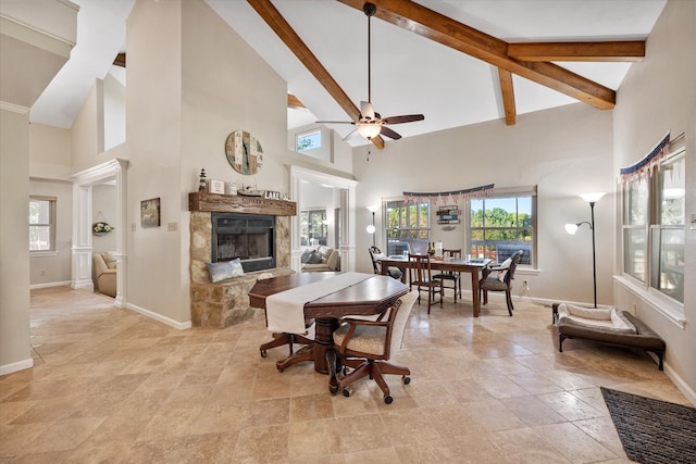 dining space with beamed ceiling, high vaulted ceiling, and ceiling fan