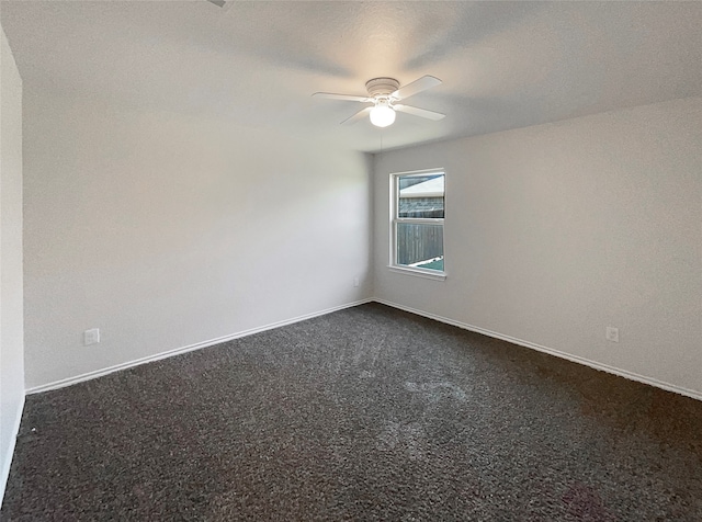 carpeted empty room featuring ceiling fan and a textured ceiling