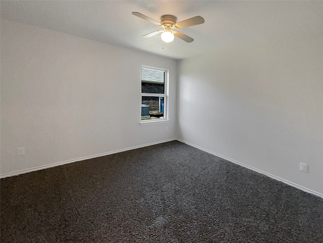 unfurnished room with ceiling fan and dark colored carpet