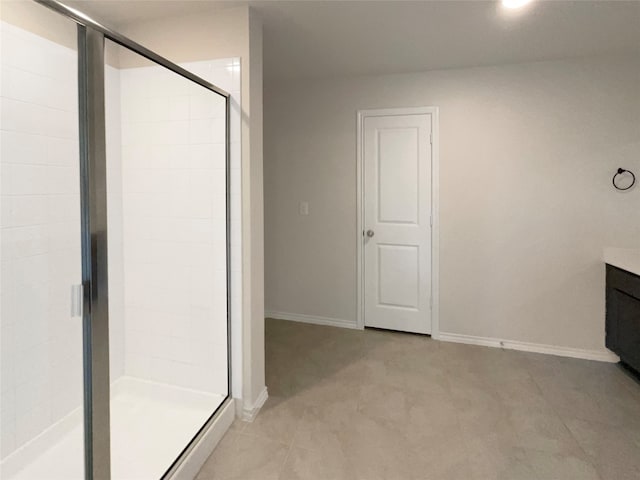 bathroom with a shower with door and vanity