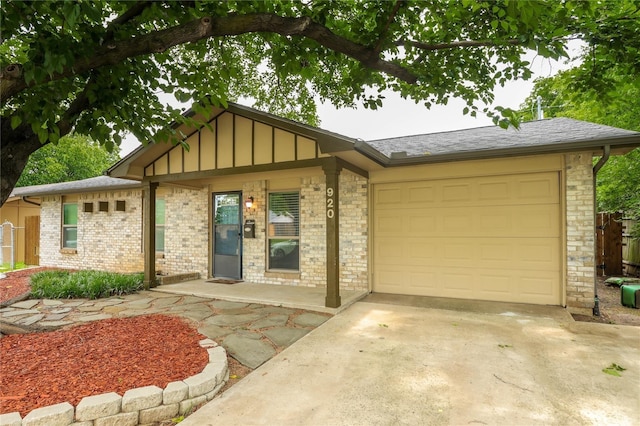 single story home featuring board and batten siding, brick siding, driveway, and an attached garage