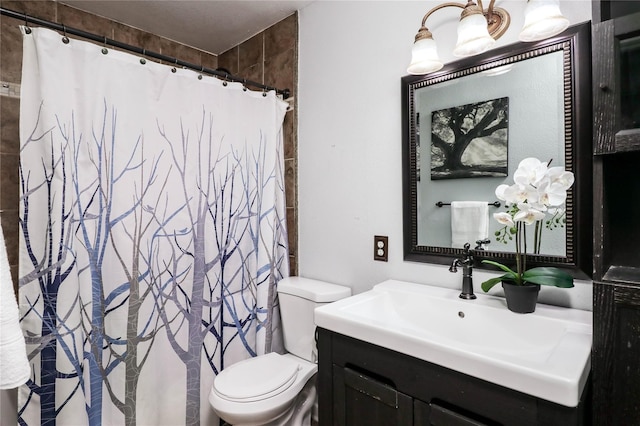 bathroom with walk in shower, vanity, and toilet