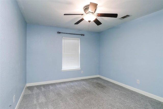 carpeted spare room with ceiling fan